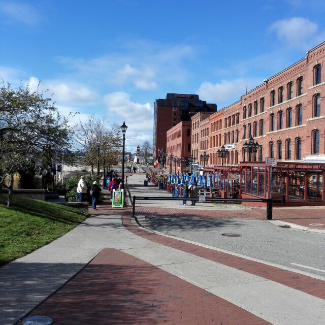 Pedestrians along a brick-lined street and walkway in Saint John