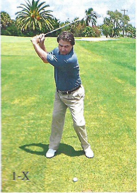 Golfer demonstrating the top of the backswing