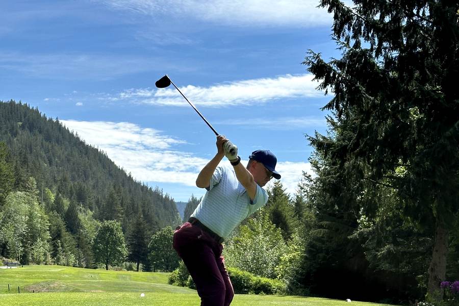 Hauwson teeing off at Furry Creek Hole 1 on May 15, 2024; the tee and grass are visible beneath the golfer.